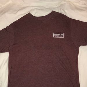 A brick red Vans shirt in the size L